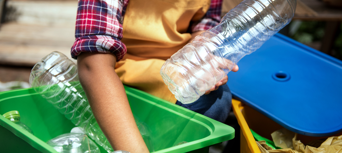 Close up of a woman recycling plastic bottles